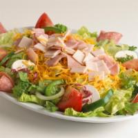 Chef Salad · Lettuce, tomatoes, turkey, ham, salami, onions, green peppers, mushrooms and cheddar cheese.