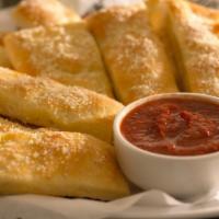 Parmesan Sticks (12Pc) · Baked dough, basted with butter and sprinkled with fresh parmesan.