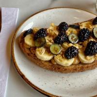 Peanut Butter Banana Power Toast · Peanut Butter, bananas, honey, black berries, blue berries, and granola on multigrain bread.