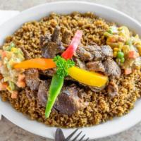 Thiebu Yapp · Lamb over fried rice served with onion sauce on the side.