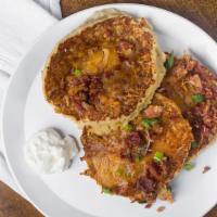 Loaded Potato Pancake · Our potato pancakes topped with cheddar-jack cheese, bacon, green onions, and sour cream.