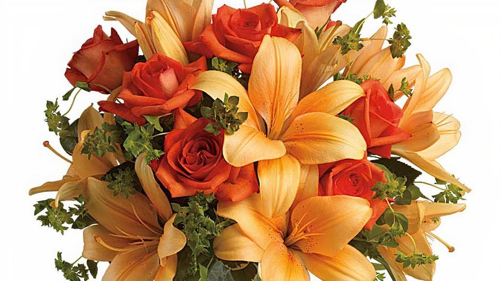 Fiery Lily & Rose · Spark someone's attention by sending this absolutely radiant bouquet. Full of flowers and fiery beauty, it makes a beautiful gift for any occasion.
Features dark orange roses and orange Asiatic lilies in a charming glass vase. It's fiery and it's fabulous!