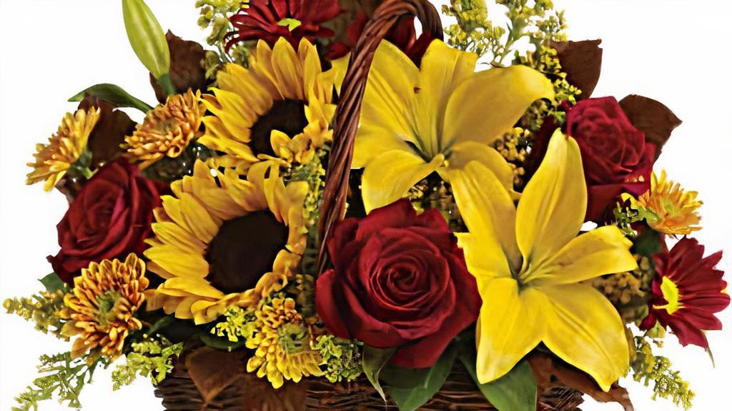 Golden Days Basket · Here's a golden opportunity to make someone's day. Just send this delightful basket of fresh fall flowers to someone who's on your mind and you can be sure it will lift their spirits!
Sunny sunflowers and Asiatic lilies, red roses, gold and burgundy chrysanthemums, solidaster, brown copper beech and salal are splendidly arranged in a wicker basket. Send it and you'll be golden, too.