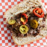 Ouilmette Cheesesteak · Griddled shaved ribeye, sautéed onions, provolone, peppercorn mayo. Served with a pickle.  A...