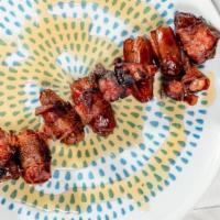 Dátiles Con Tocino · Gluten-free. Dates wrapped in bacon and drizzled with honey.