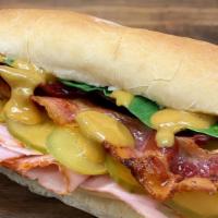 Double Squealer · Ciabatta, carved ham, bacon, lacey swiss, honey mustard, spinach, pickles.