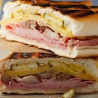 Cuban Sandwich · Wood roasted pork and sweet ham topped with thin-sliced pickles, Austin’s sauce, and Swiss c...