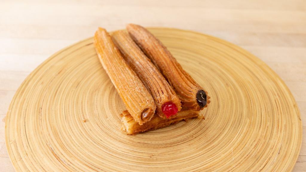 Churros (3) · Fried dough pastry filled with chocolate, strawberry or cajeta syrup.