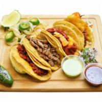 Tacos (3) · Al pastor, or carne asada, topped with cilantro, and onion, served with a side of grilled on...