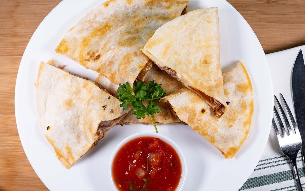 Quesadilla Rellena · 2 flour tortillas, grilled and stuffed with cheese, chopped beef or chicken. Served with guacamole salad and sour cream.