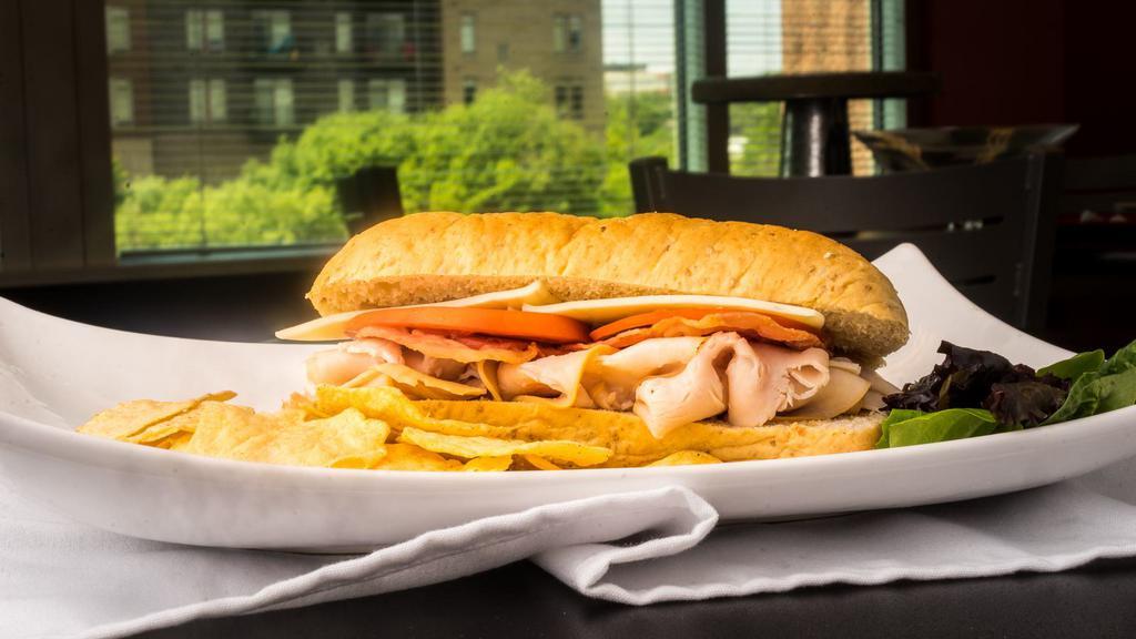 Turkey Club · Wheat hoagie, turkey, bacon, pepper jack cheese, tomatoes, red onions, chipotle mayo.