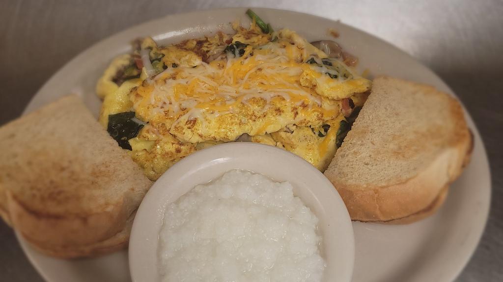 Vegetarian · 3 eggs with tomatoes, spinach, mushrooms, green peppers, onions and topped with shredded cheese.