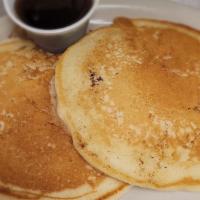 (2) Pancakes · 2 golden brown pancakes served with syrup.