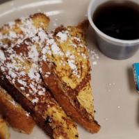 (2) Slices Of French Toast · 2 French toast sprinkled with powdered sugar and served with syrup.