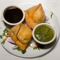 Av2 - Samosa (2 Pieces) · Deep-fried flaky pastry stuffed with potatoes and peas served with fresh mint and tamarind s...