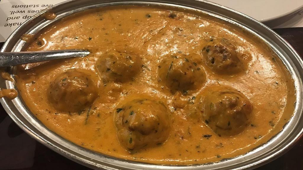 Ev10 - Malai Kofta · Cottage cheese, potatoes, and spices mixed together and then finished in hot oil and served with a creamy gravy made of crushed cashews and spices. (646 — 675 Calories).