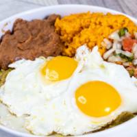 Huevos Chilaquiles · Mexican-style scrambled eggs with corn tortillas and green chile sauce. Served with rice, be...