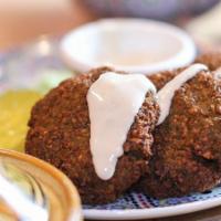 Falafel · 4 Lebanese-Style Crispy Patties of Ground
Chickpeas Served with Tahini Sauce