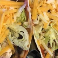 Smokehouse Tacos · Pulled chicken, pork or brisket (for an extra cost), black beans & lettuce in a flour tortil...