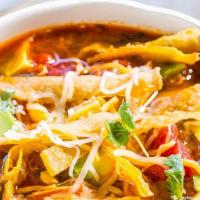 Tortilla Soup · Made with chicken, black beans, corn, cheese, avocado, and tortilla chips.