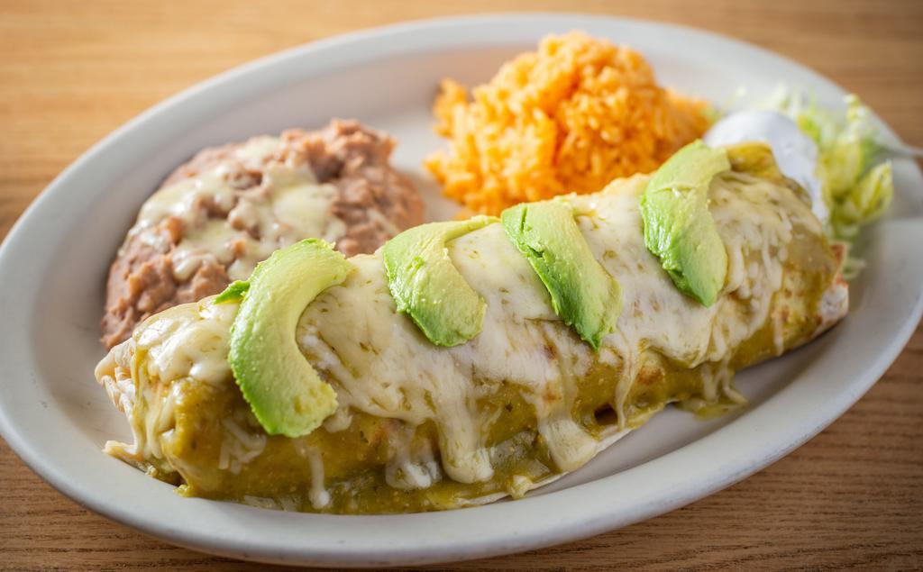 Burrito Supreme Dinner · Topped with green mole, melted cheese, and avocado. Choice of meat: steak, chicken, shredded beef, ground beef, al pastor or veggie.
