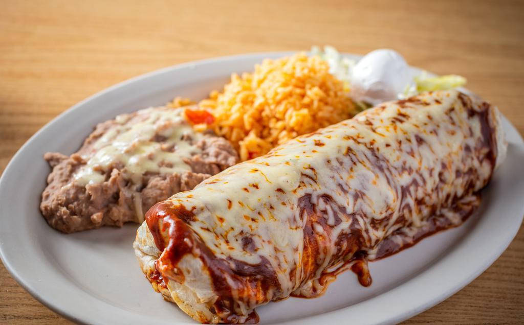 Burrito Suizo Dinner · Topped with red mole and melted cheese. Choice of meat:steak, chicken, shredded beef, al pastor, ground beef or veggie. Shrimp $4 extra.
