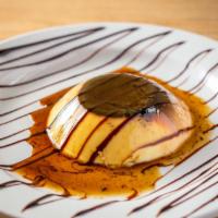Flan · Traditional mexican dessert custard with a hint of caramel decorated with chocolate syrup an...