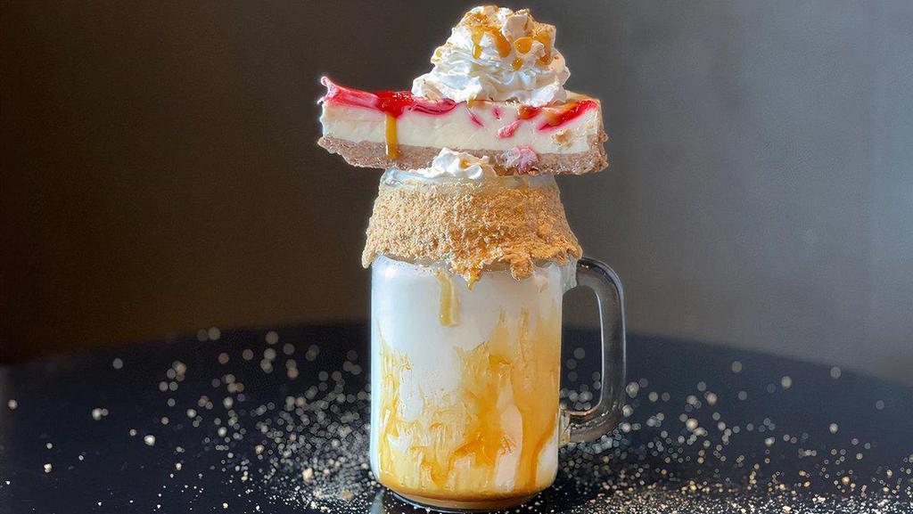 Caramel Cheesecake Craze · A caramel to-go cup coated with graham cracker dust, 
filled with rich vanilla ice cream. Topped with a slice of 
cheesecake, whipped cream, graham crack dust, and 
caramel drizzle.

Note: Images shown are how our amazing shakes look in store. They will taste just as amazing in your home, but may look a bit different. The shake will come deconstructed, and we will include all the items necessary to top your own!