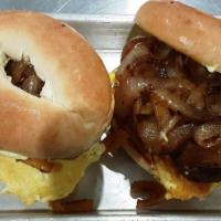 Breakfast Bagel · Steak, ham or bacon topped with sautéed onions, a fluffy scrambled egg, cheddar cheese and t...