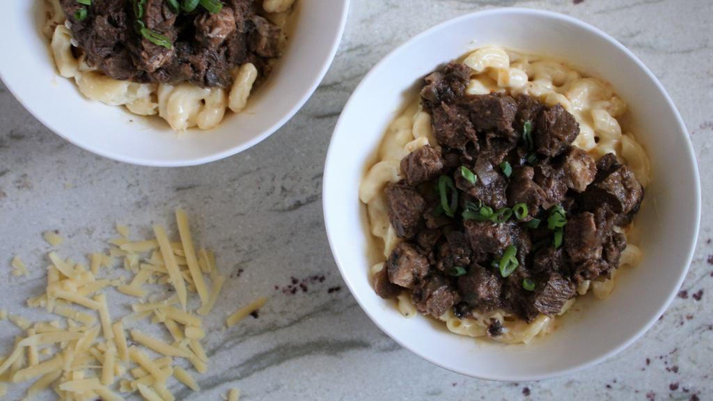 Tender Beef Brisket Macaroni & Cheese · Topped with tender beef brisket in a mushroom veal demi glaze and scallions.