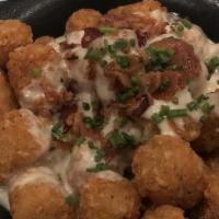 Loaded Tater Tots · Queso, smoked bacon bits, chives, cilantro sour cream served on the side. / Any additional s...