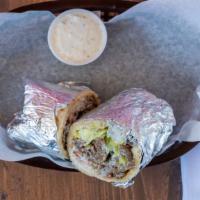 Gyro Sandwich · Traditional gyro slices, lettuce, tomatoes, onions, and tzatziki sauce; served over pita bre...