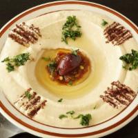 Hummus Dip · Vegan. Mashed Chickpeas, tahini, lemon, olive oil; served with a side of pita bread.