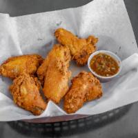 Chicken Wings · Spicy tender chicken wings; deep-fried served with hot sauce on the side.