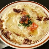 Baba Ghanoush Dip · Vegan. Roasted eggplant purée, tahini, lemon, and spices; served with pita bread.