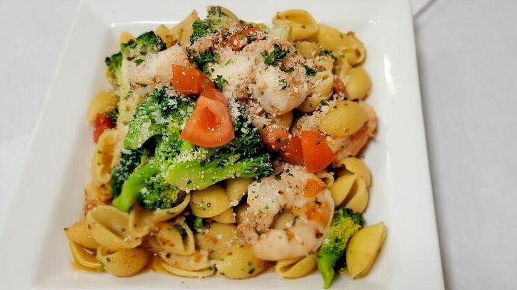 Orecchiette Baresi · Shell pasta with shrimp, broccoli and fresh tomatoes in garlic and olive oil sauce. Topped with Pecorino Romano cheese.