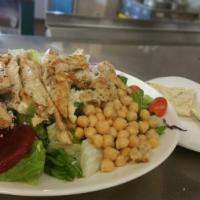 Grilled Chicken Salad · Warm tender slices of marinated chicken on a bed of greens with tomato, cheese and a hard bo...
