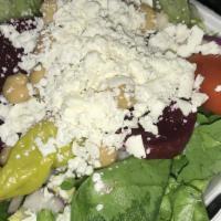 Famous Greek Salad (Baby) · Crisp lettuce, tomato, beets, peppercinis, Greek olives, feta cheese, garbanzo beans, onions...