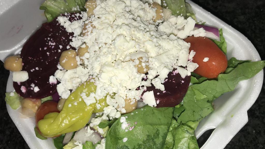 Famous Greek Salad (Baby) · Crisp lettuce, tomato, beets, peppercinis, Greek olives, feta cheese, garbanzo beans, onions. Greek dressing and pita bread.