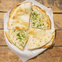 Garlic Naan
 · Leavened bread topped with fresh shredded garlic and herbs then baked in our tandoori clay o...