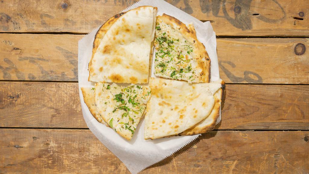 Garlic Naan
 · Leavened bread topped with fresh shredded garlic and herbs then baked in our tandoori clay oven.