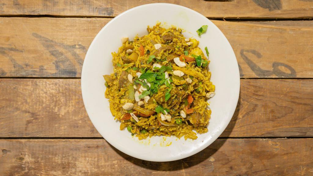 Goat Biryani · Freshly cut goat cooked with our variety of spices and lightly seasoned with a little saffron, served with raita sauce.