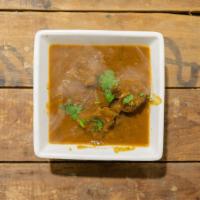 Goat Curry With Bone · Bone in cut pieces of goat cooked in heavenly curry sauce and seasoned to your taste.