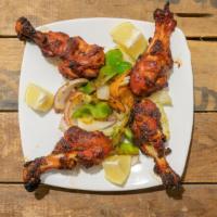 Tandoori Chicken Legs · Chicken legs marinated with ginger, yogurt, fresh ground spices and lemon juice then cooked ...