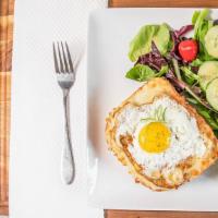 Croque Madame · Baked ham and cheese sandwich with bechamel and topped of an egg sunny side up.
