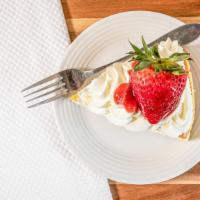 Stawberry Cheesecake · Homemade cheesecake topped with a fresh strawberry and coulis