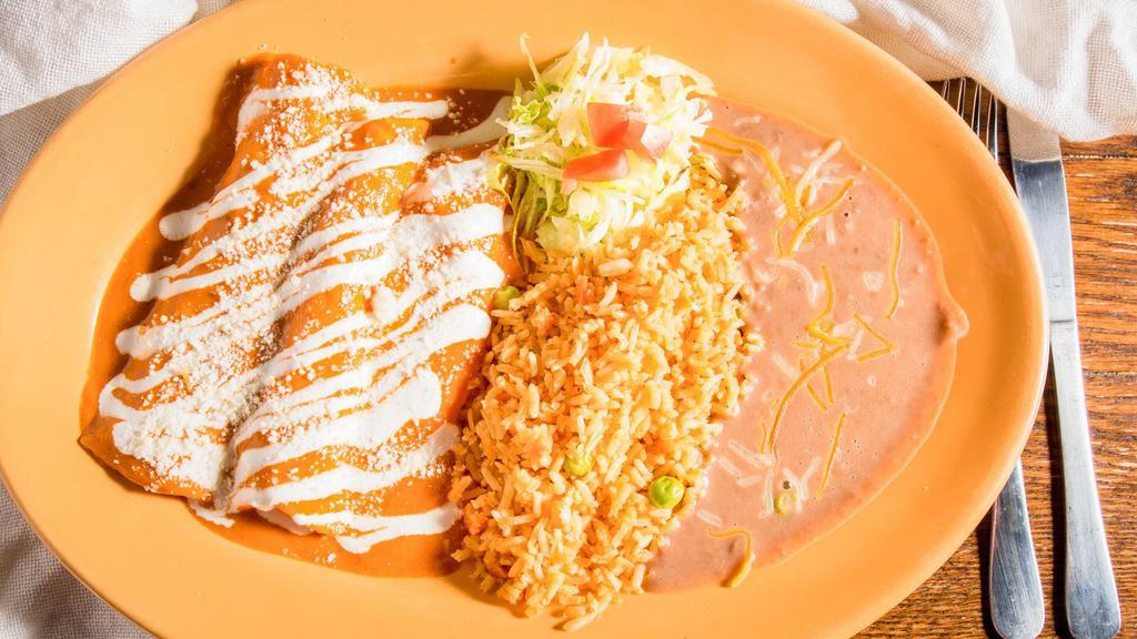 Enchiladas · Three corn tortillas filled with cheese and your choice of meat covered with your choice of sauce served with rice, beans and lettuce.