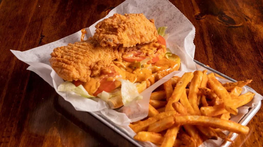 Fried Catfish Po Boy Sandwich · Served with tomato, lettuce, remoulade sauce, and fries. Choice of fries: Cajun fries, regular fries, or sweet potato fries.