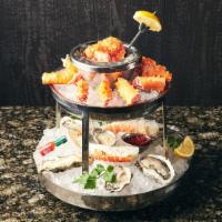 Seafood Tower · Alaskan king crab, oysters, south African lobster tail, St. Elmo shrimp cocktail.