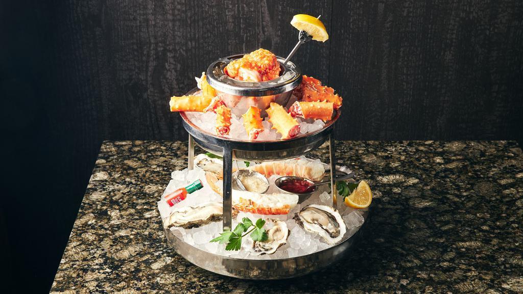 Seafood Tower · Alaskan king crab, oysters, south African lobster tail, St. Elmo shrimp cocktail.